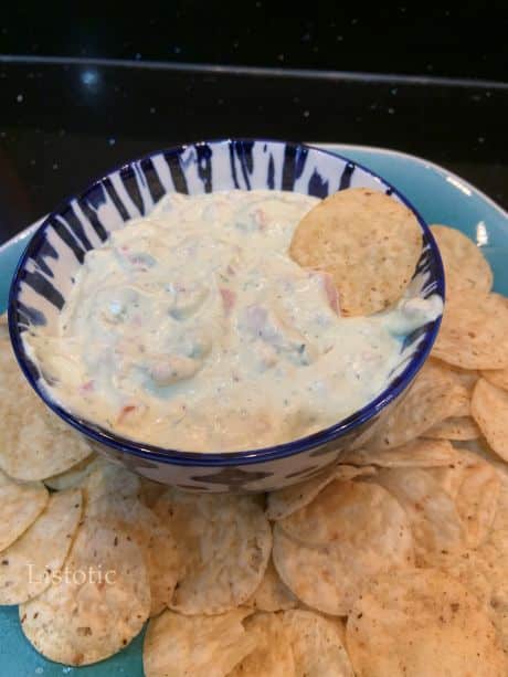 A bowl of avocado ranch dip served with tortilla chips.