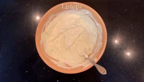 A bowl of sour cream, dry ranch poder, and avocado.