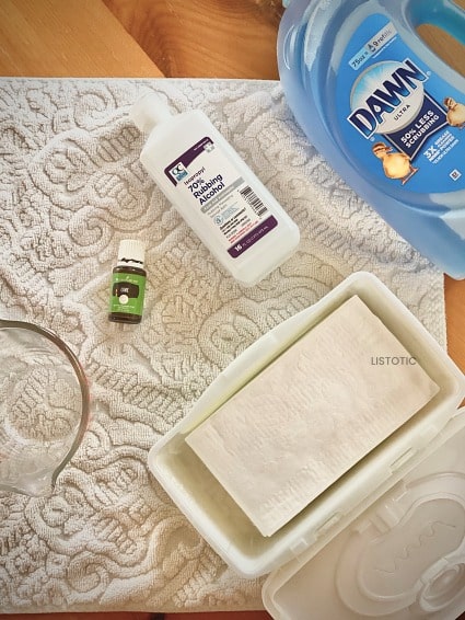 towel with baby wipes dish soap rubbing alcohol and essential oil materials to make DIY Lysol Wipes wipes 