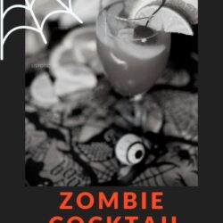 Black and white image of a cocktail on a Halloween table with spider web graphics