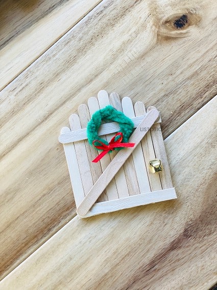 miniature holiday wreath on a magical elf entrance