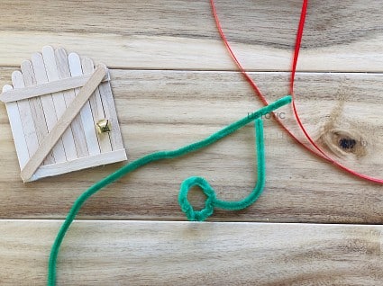 green pipe cleaner and red ribbon to make a miniature holiday wreath