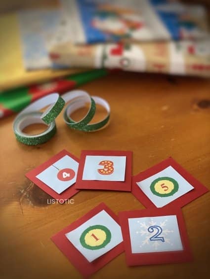materials like glitter tape and cut numbers for Countdown to Christmas for Kids activity