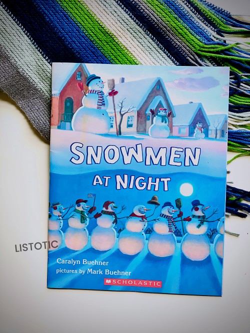 Snowmen at night book on top of a scarf for Christmas stories read aloud