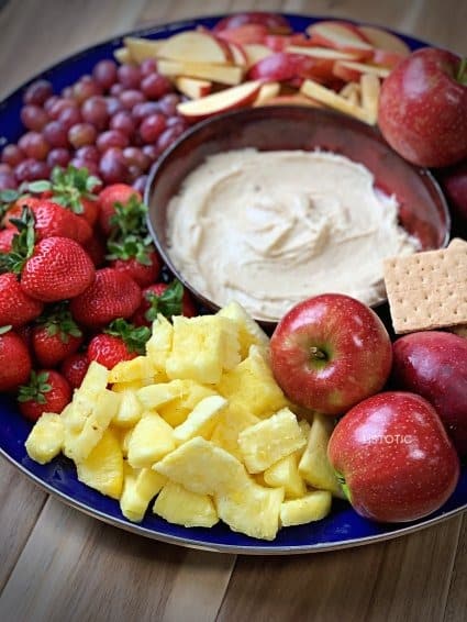 colorful fruit tray and fruit dip that is a kid friendly appetizer for a party