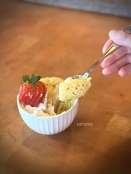 hand scooping up a spoonful of a recently made dessert