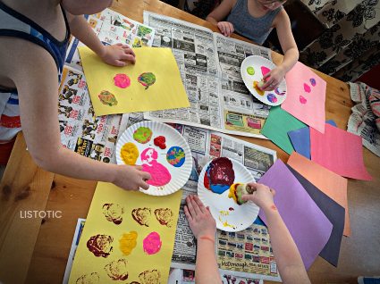 kids making artwork with finger paint