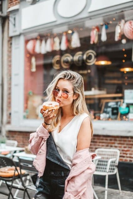 portrait of woman eating donut