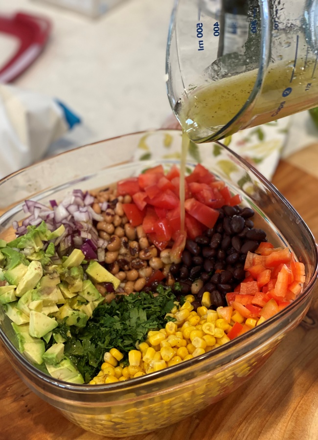 cowboy caviar dressing mixture added to chopped up ingredients