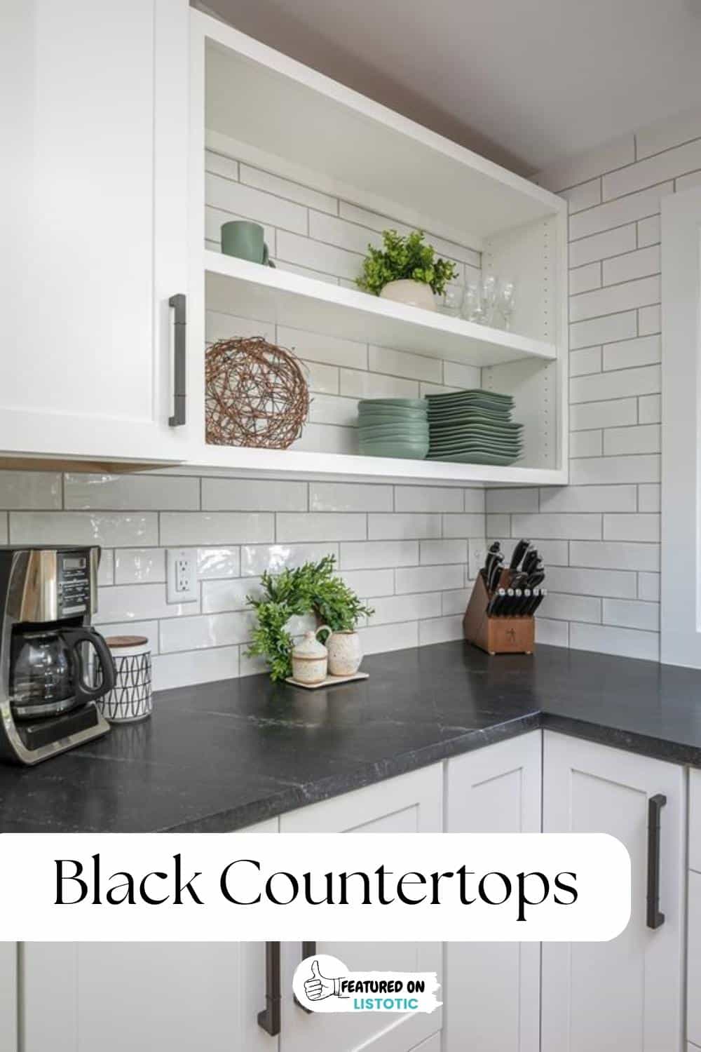 black countertop with faint white marbling and white shaker kitchen cabinets