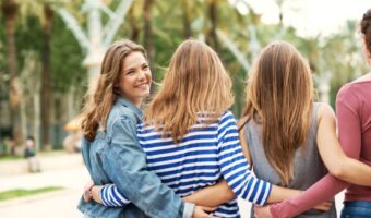 friends with arms around their backs